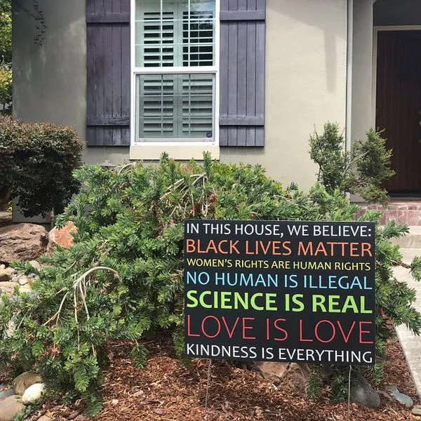 In This House We Believe yard sign